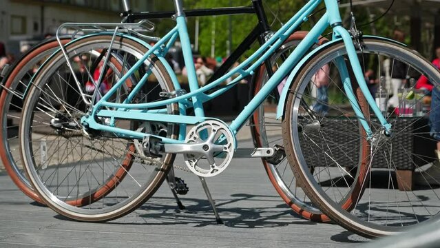 Classic City Bikes Parked by Busy Boulevard on Sunny Spring Day