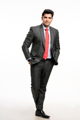 Young indian businessman in classic suit giving expression.