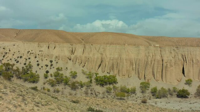 Aerial view of sandy canyon. Video with picturesque view of mountain landscape, Kyrgyzstan, Central Asia.