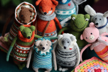 Fototapeta na wymiar Crochet stuffed animals close up photo. Hand made Amigurumi toys on dark background with copy space. Cute crochet gift. 