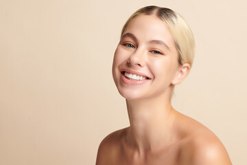 Beautiful smile of young woman with healthy white teeth on beige background, Dental care. Dentistry...