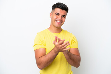 Young caucasian handsome man isolated on white background applauding after presentation in a...