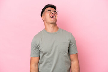Obraz premium Young caucasian handsome man isolated on pink background laughing