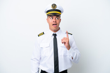 Airplane pilot caucasian man isolated on white background thinking an idea pointing the finger up