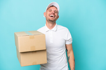 Delivery caucasian man isolated on blue background laughing