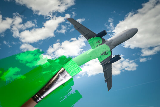 brush painting green an aircraft. Greenwashing malpractice, Zero emissions, SAF or Sustainable Aviation Fuel and biofuel concepts.