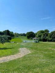 Lush green walking area near a golf course