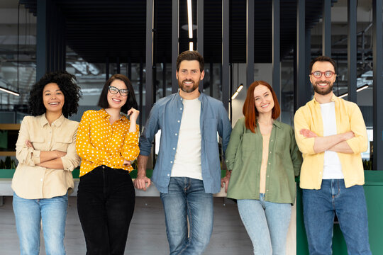 Confident portrait of a diverse millennial business partners smiling, looking at camera