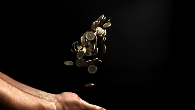 Hands tossing coins up. Filmed is slow motion 1000 fps. High quality FullHD footage