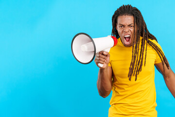Angry latin man with dreadlocks shouting using a megaphone