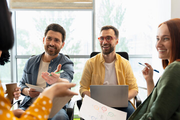 Sales managers analyze sales growth charts, working on developing business strategies in the office