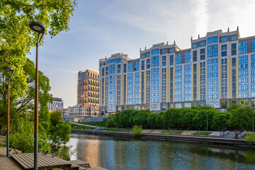 New high-rise buildings on the river bank in the city center.