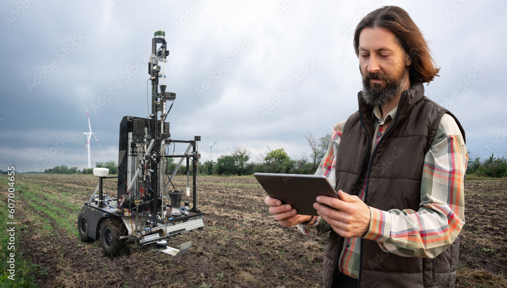Poster farmer controls autonomous robot for measuring soil quality in an agricultural field. smart farming 