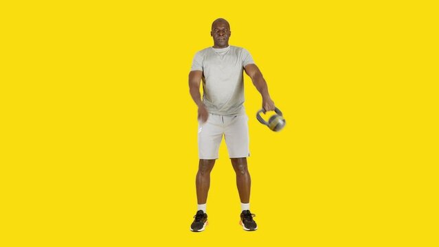 Strong african man doing around the world exercise with kettlebell