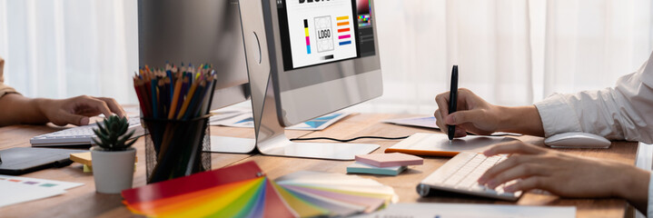 Graphic designer work on computer laptop and with graphic drawing pen while brainstorming unique...