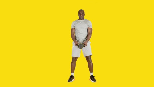 African man doing frontal shoulder raise exercises with kettlebell