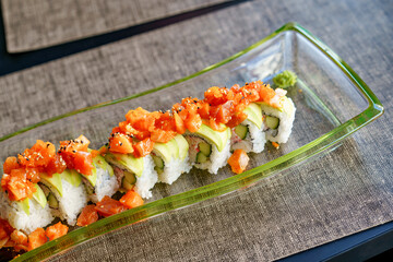 Philadelphia roll sushi with salmon, smoked eel, cucumber, avocado, cream cheese, red caviar. Sushi menu. Japanese food.
