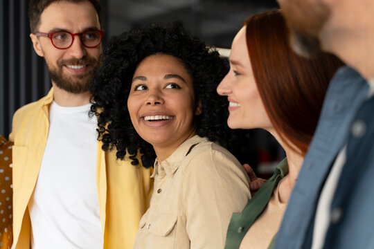 Close-up portrait of a happy business people smiling cheerfully during a meeting in creative office.