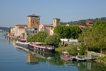 VIENNE, FRANCE, May 26, 2023 : Valois tower, built in 1336 by French King Philippe VI and Cordeliers church on the right bank of Rhone river. - obrazy, fototapety, plakaty