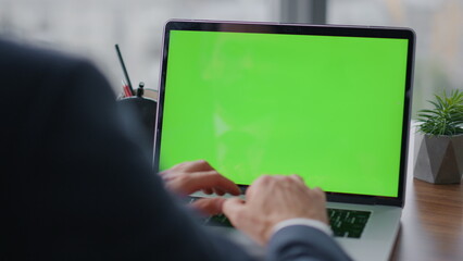 Entrepreneur typing mockup laptop at office close up. Manager using green screen