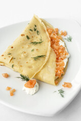 smoked salmon and sour cream crepe pancake on white background - 607015049