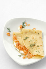 smoked salmon and sour cream crepe pancake on white background