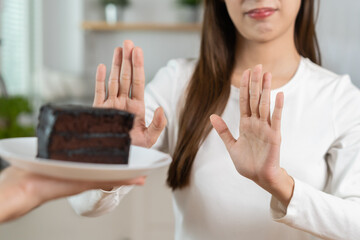 Diet, Dieting unhealthy asian young woman hand in push out, rejecting eat chocolate cake or sweet...