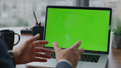 Manager having call green screen laptop at office close up. Man using computer.
