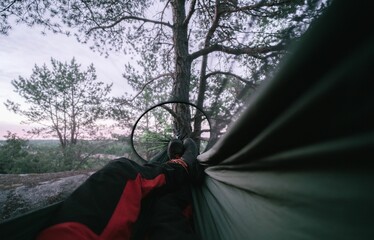Man lying in a hammock in the nature