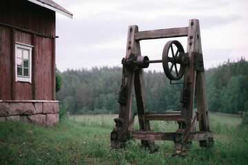 Old wooden log splitter in a rural environment on a cloudy day