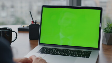 Businessman working greenscreen laptop in office close up. Man using chroma key