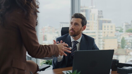 Fototapeta premium Relaxed coworkers communicating office closeup. Woman sharing ideas with manager