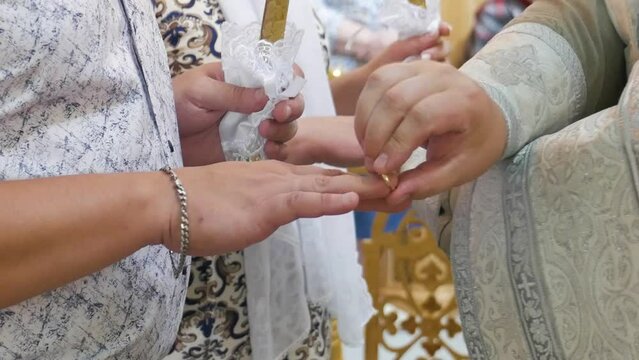 Orthodox priest conducts wedding ceremony with rings