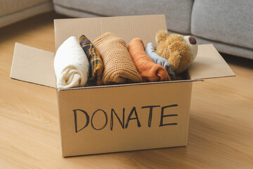 Recycling, Donation for poor, packing object at home, putting on stuff into donate box with second...