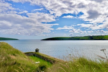 Beautiful shot of fields by the sea in the daytime