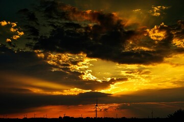 Scenic view of wind turbines in a field during a mesmerizing cinematic sunset