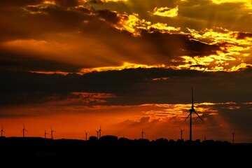 Scenic view of wind turbines in a field during a mesmerizing cinematic sunset