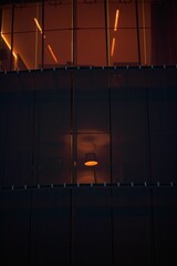 Vertical shot of a lamp seen from a window of a tall building at night