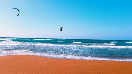 A group of people kite surfing at Alagadi Beach in Kyrenia, North Cyprus on sunny day with clear sky