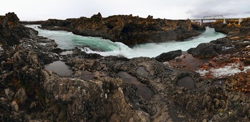 Panoramic view of a beautiful waterfall near the rocks in Iceland