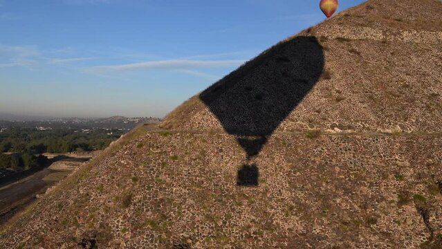 The shadow of a hot air balloon soars over the the ancient Pyramids of the Moon and Sun in Teotihuacan, Mexico.