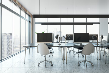 Contemporary coworking office interior with desks, chairs, equipment and panoramic window with city view and daylight. 3D Rendering.