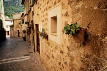 Fototapeta na wymiar Side view of old stone Historical houses of Valldemossa village in Mallorca, Spain