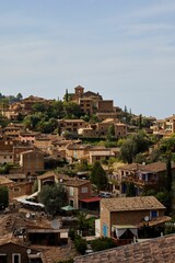 Fototapeta na wymiar Aerial view of cityscape Deia surrounded by buildings