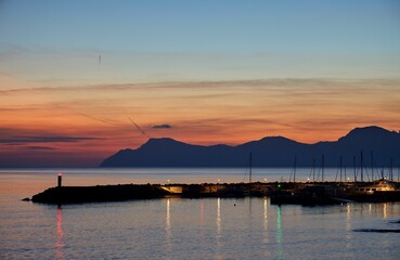 Aerial view of sea with port during sunset