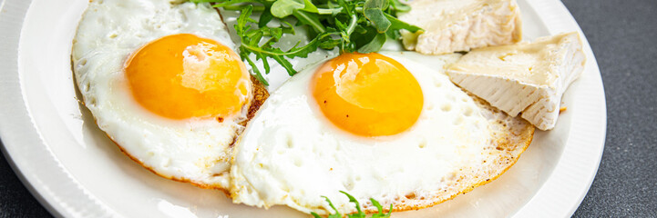 fried egg with sausages breakfast green leaves lettuce arugula healthy meal food snack on the table copy space food background rustic top view