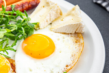 fried egg with sausages breakfast green leaves lettuce arugula healthy meal food snack on the table copy space food background rustic top view