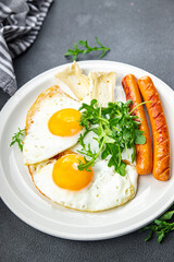fried egg with sausages breakfast green leaves lettuce arugula healthy meal food snack on the table copy space food background rustic top view