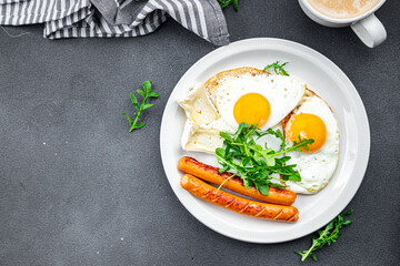 fried egg with sausages breakfast green leaves lettuce arugula healthy meal food snack on the table copy space food background rustic top view