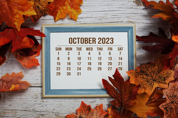 September 2023 monthly calendar maple leaf decoration on wooden background